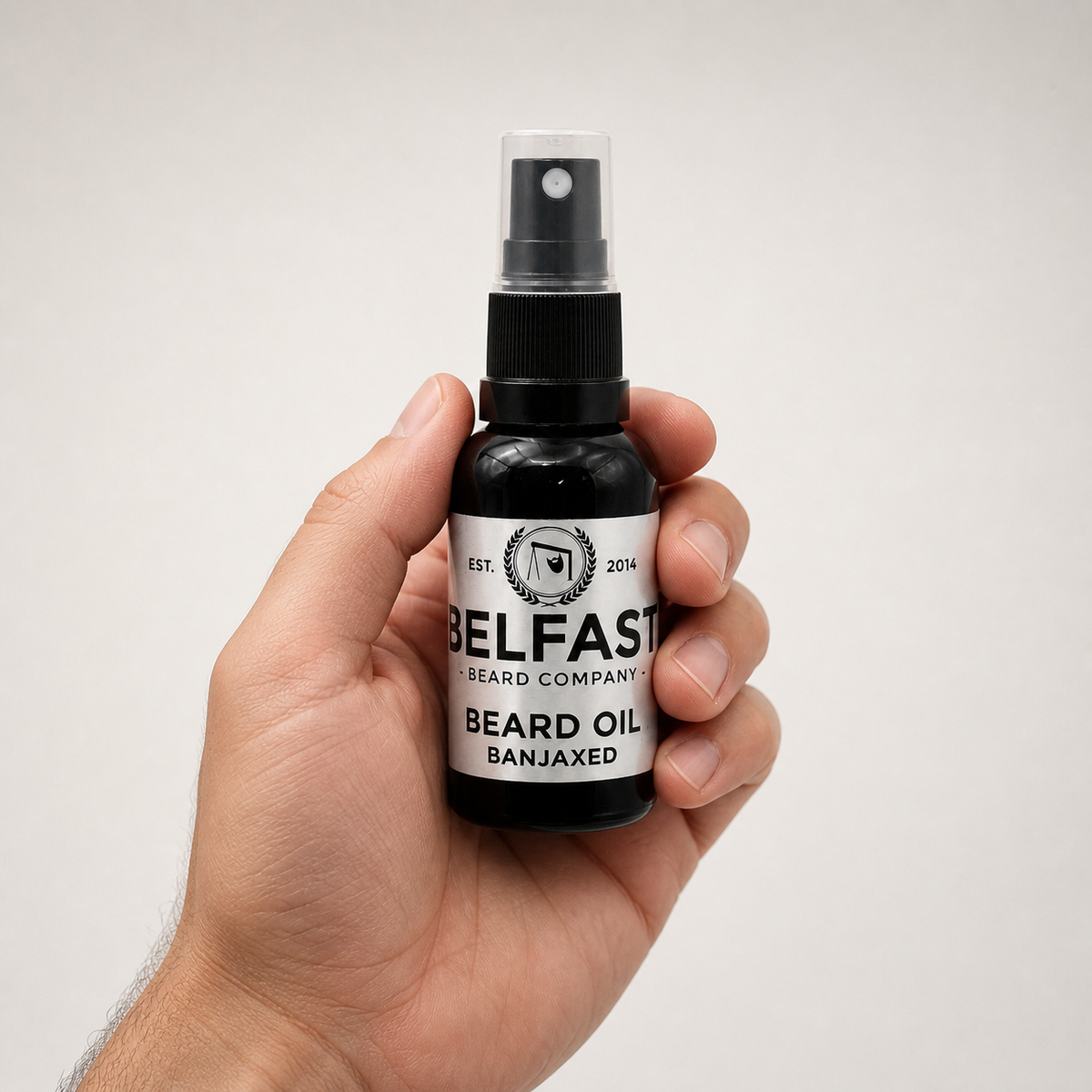 Banjaxed Beard Oil 30ml held in a hand to show its size