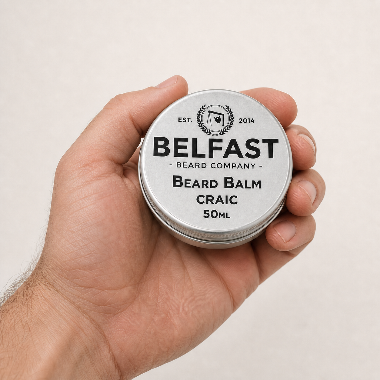 Craic Beard Balm 50ml held in a hand to show its size