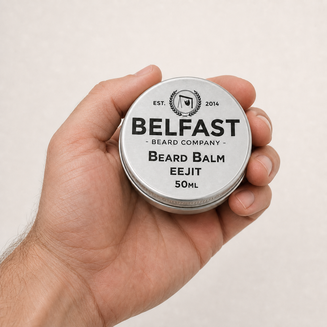 Eejit Beard Balm 50ml held in a hand to show its size
