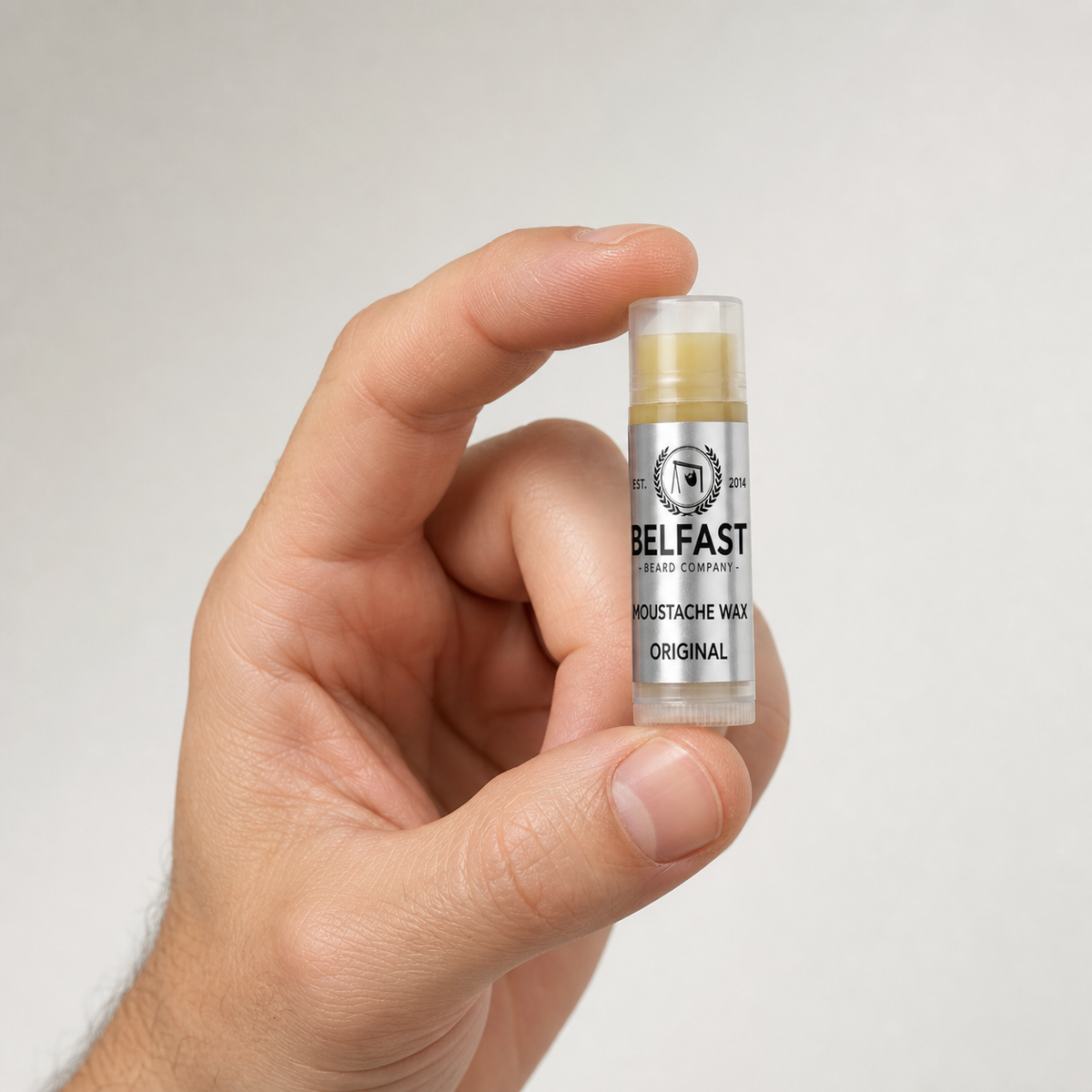 Original Lippy Moustache Wax 5ml held in a hand to show its size