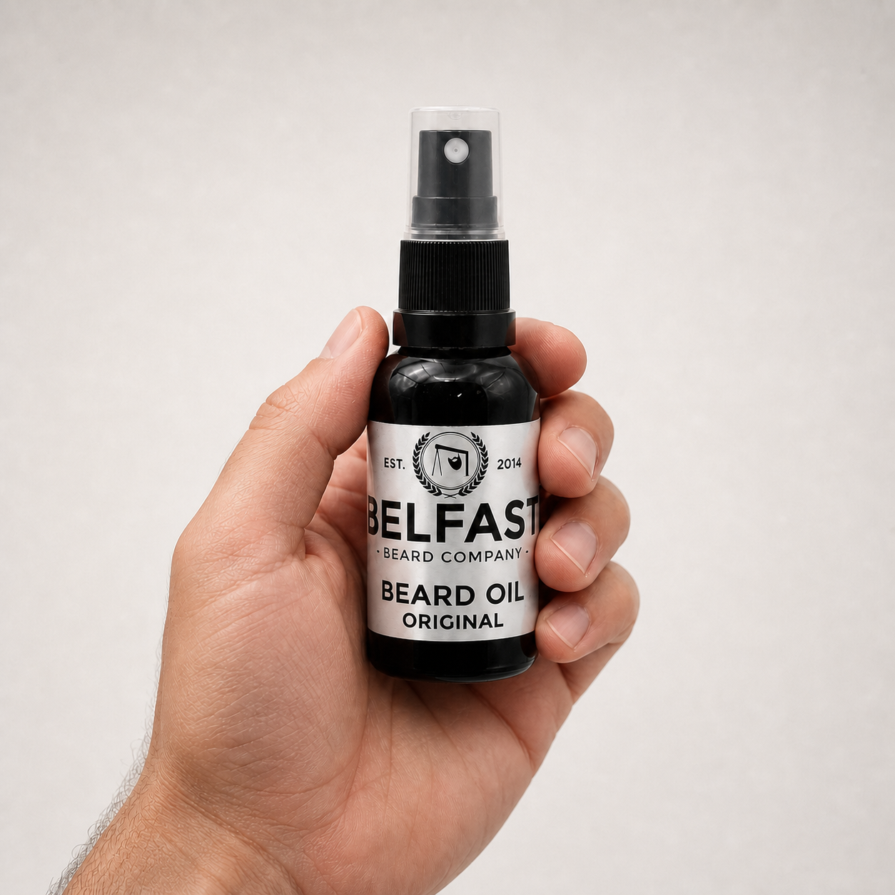 Original Beard Oil 30ml held in a hand to show its size