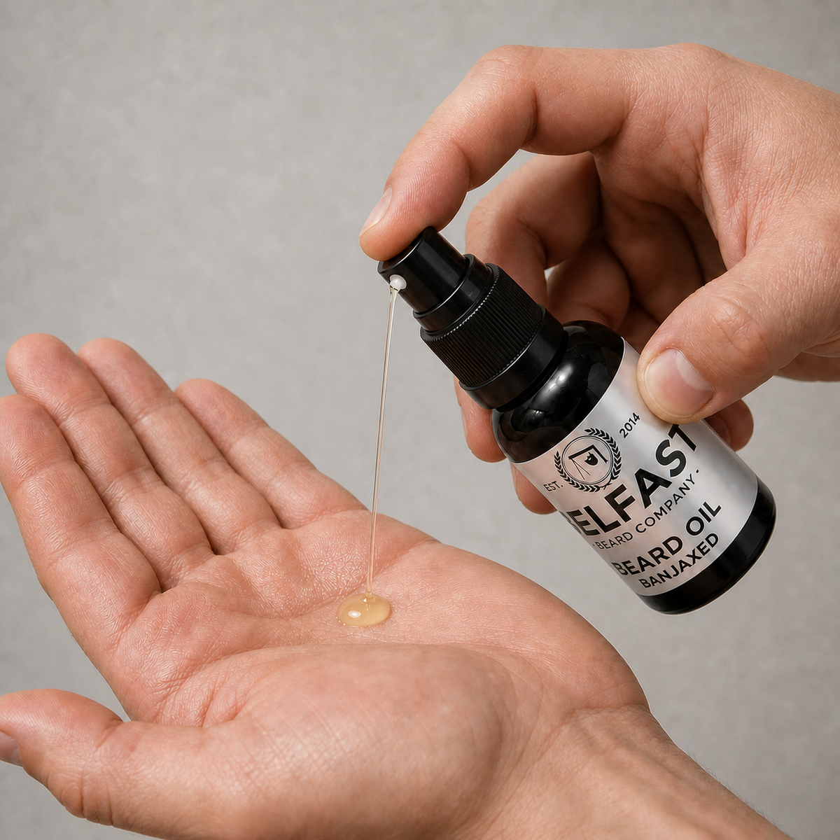 Hand dispensing Banjaxed Beard Oil 30ml from the atomiser into an open palm