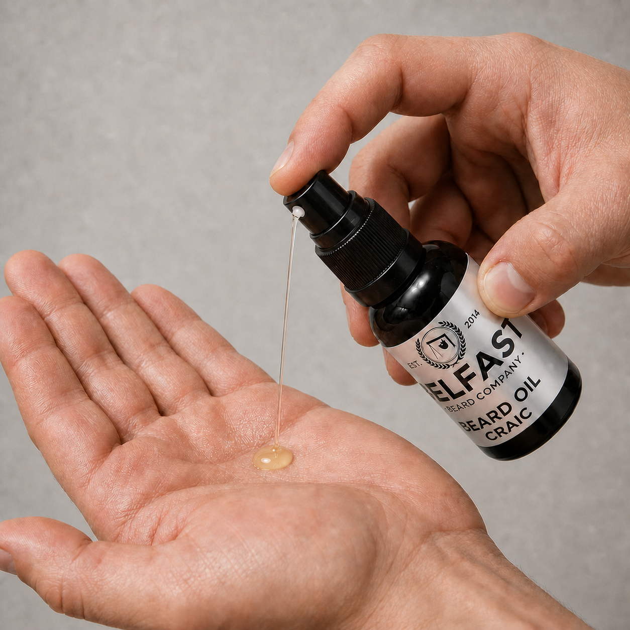 Hand dispensing Craic Beard Oil 30ml from the atomiser into an open palm