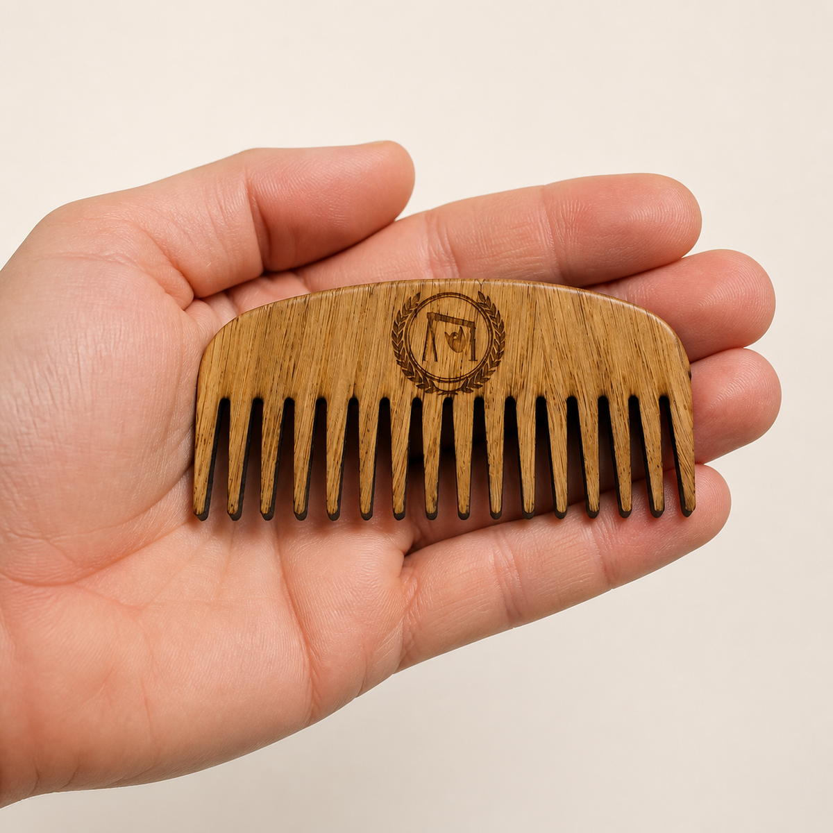Oak Beard Comb held in a hand to show its size