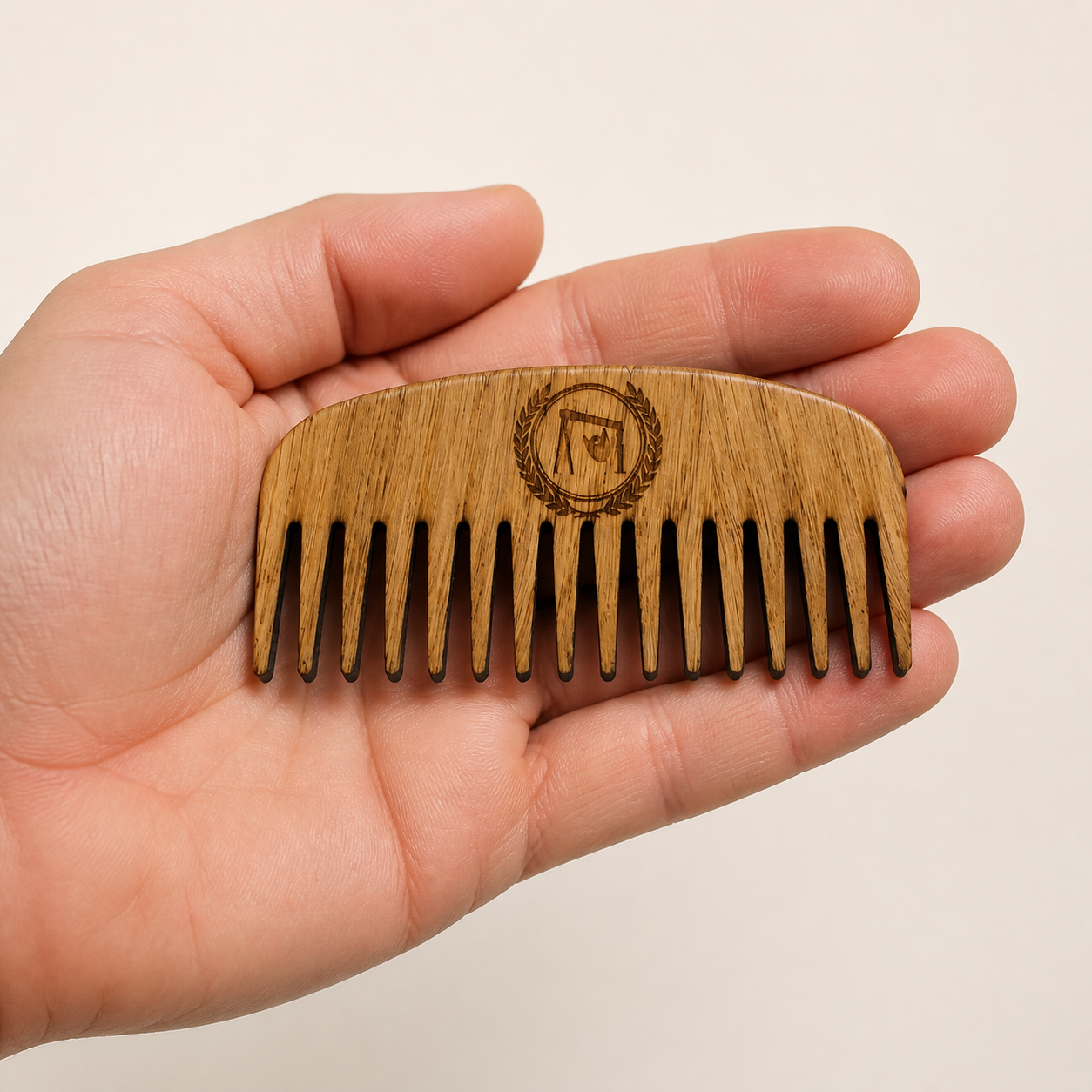 Oak Beard Comb held in a hand to show its size