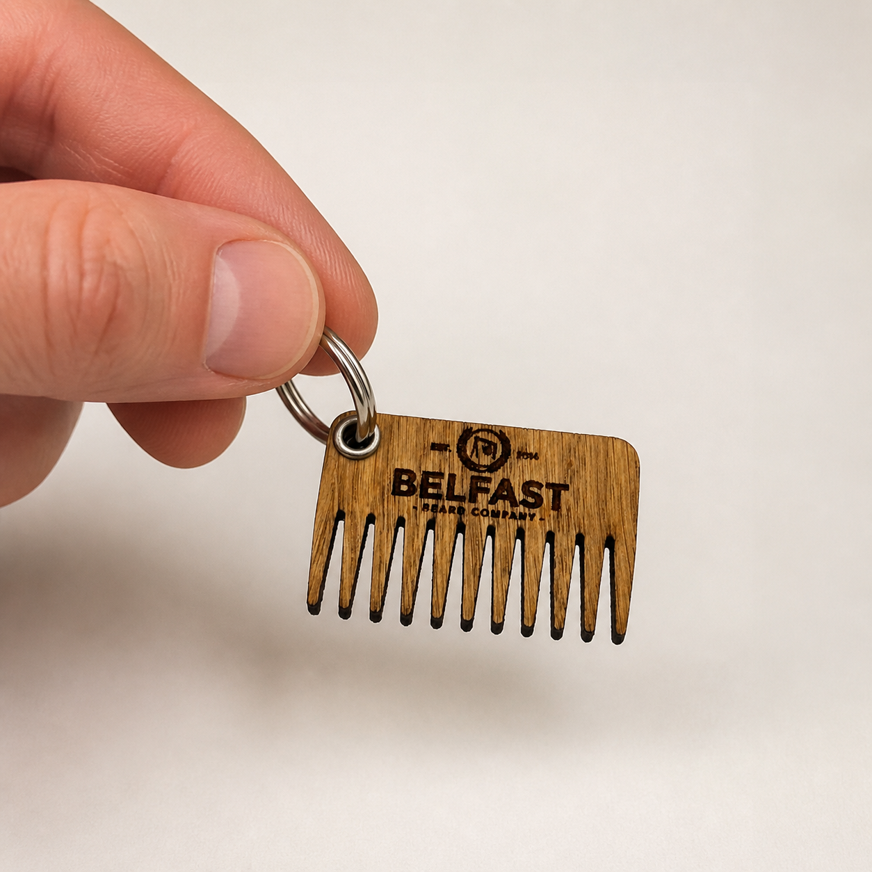 Oak Beard Comb held in a hand to show its size